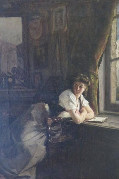Young woman at her window in home office