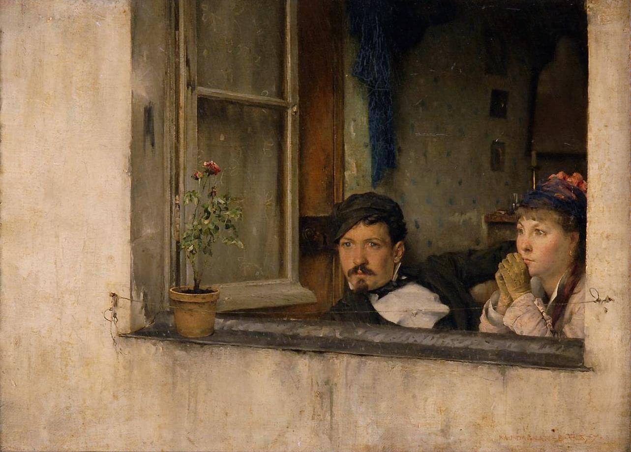 A young man and woman gaze out a window