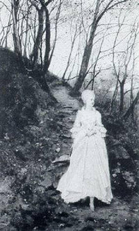 An elegant lady walking on a woodland path