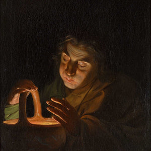 A man blowing on a lamp