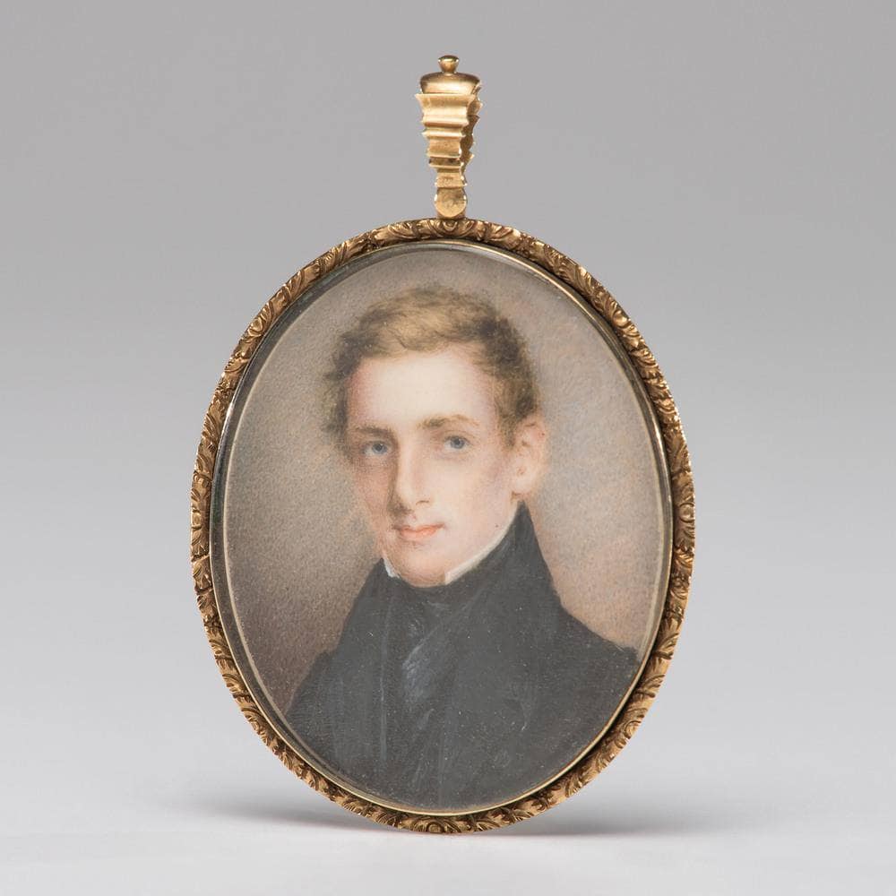A portrait miniature of a young man on ivory, housed in a gold case with a lock of hair to verso