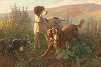 Three hunting dogs in a landscape with mountains in the distance