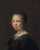 Portrait of a girl, bust-length, in a black dress and pearl necklace in living room