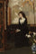 In the studio - young woman pensively looks at a picture on an easel in dining room