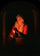Old woman with a candle in bedroom