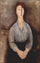 Seated woman weared in blue blouse in entryway